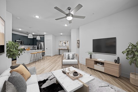 a living room with a ceiling fan and a television